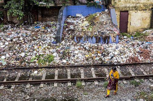 Индиска жена поминува покрај ѓубре во Калкута