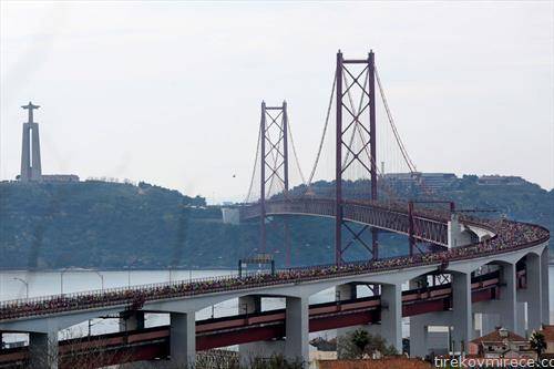  атлетичари го минуваат мостот  преку реката Тагус за време на нивното учество на Лисабонски полу-маратон 